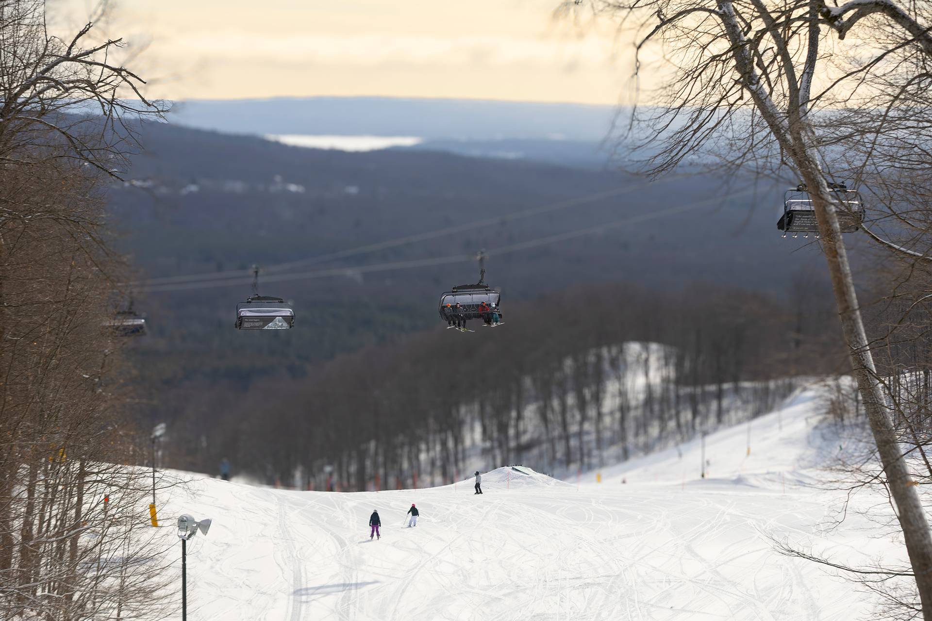 A drone shot of Camelot 6 with skiers sitting on it.