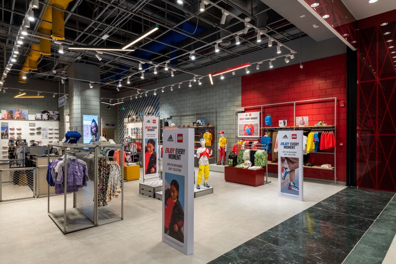 A wide-angle, exterior view of the **Lloyd's Building** in London, showcasing its distinctive inside-out architecture with exposed pipes, ducts, and service elements on the facade. The building stands tall against the skyline, reflecting the surrounding urban environment.