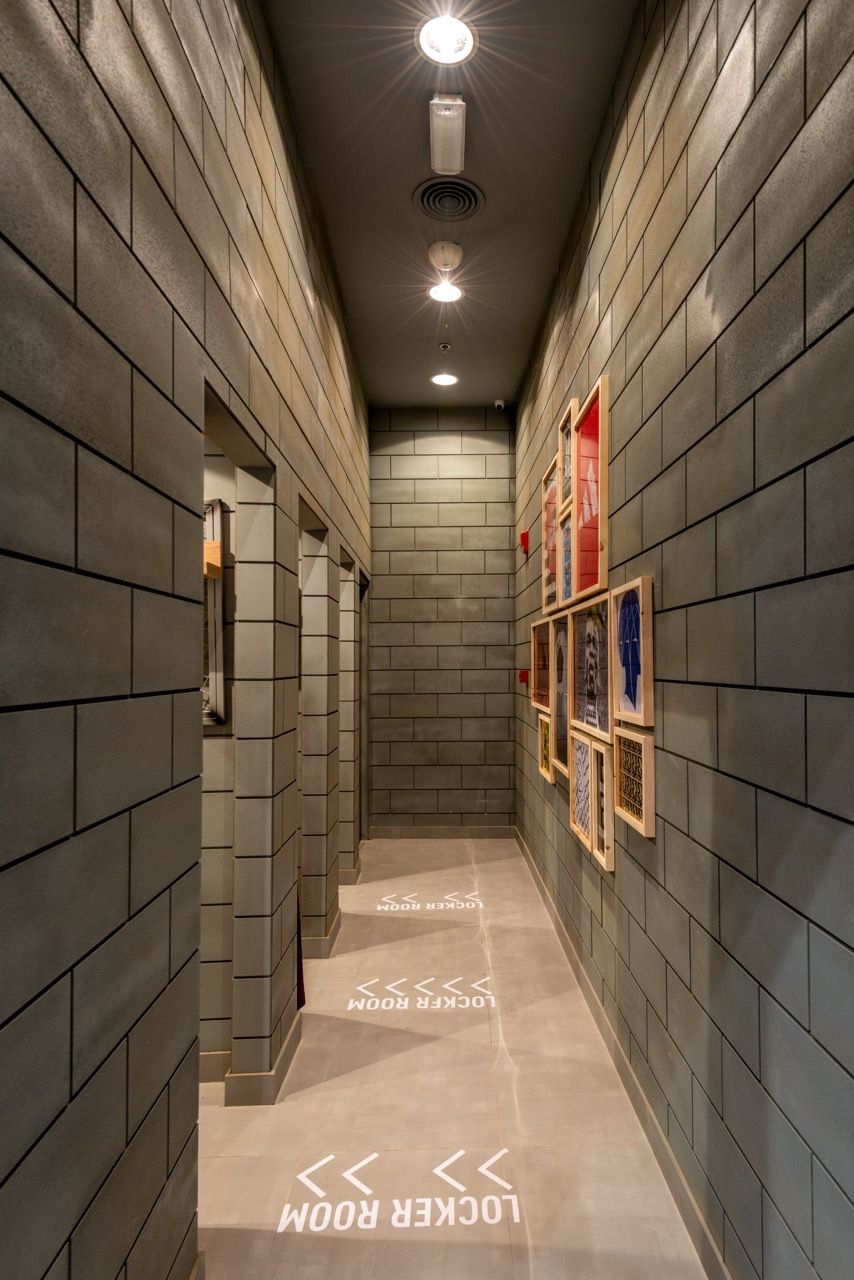 A wide-angle, exterior view of the **Lloyd's Building** in London, showcasing its distinctive inside-out architecture with exposed pipes, ducts, and service elements on the facade. The building stands tall against the skyline, reflecting the surrounding urban environment.