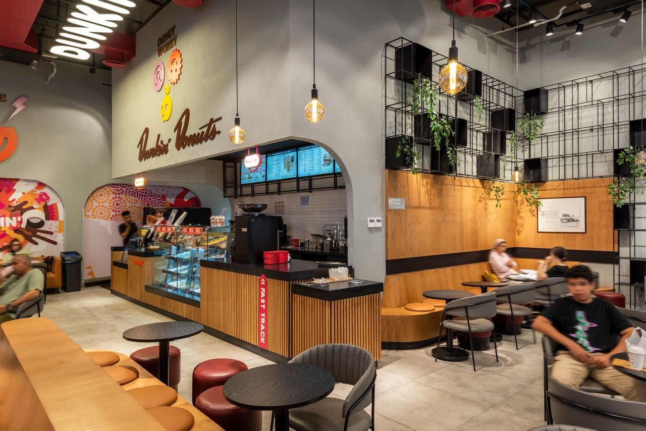 A wide-angle, exterior view of the **Lloyd's Building** in London, showcasing its distinctive inside-out architecture with exposed pipes, ducts, and service elements on the facade. The building stands tall against the skyline, reflecting the surrounding urban environment.