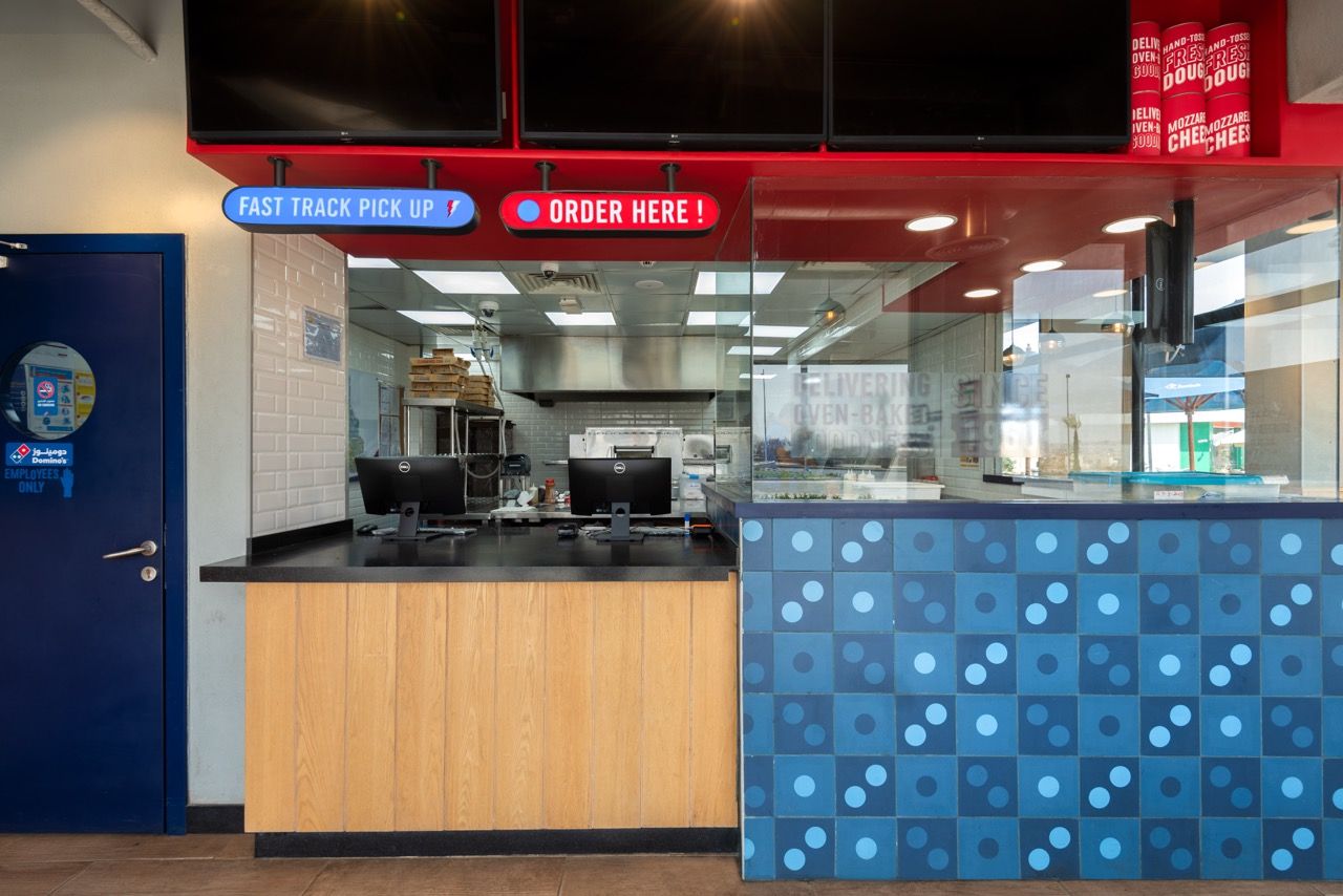 A wide-angle, exterior view of the **Lloyd's Building** in London, showcasing its distinctive inside-out architecture with exposed pipes, ducts, and service elements on the facade. The building stands tall against the skyline, reflecting the surrounding urban environment.