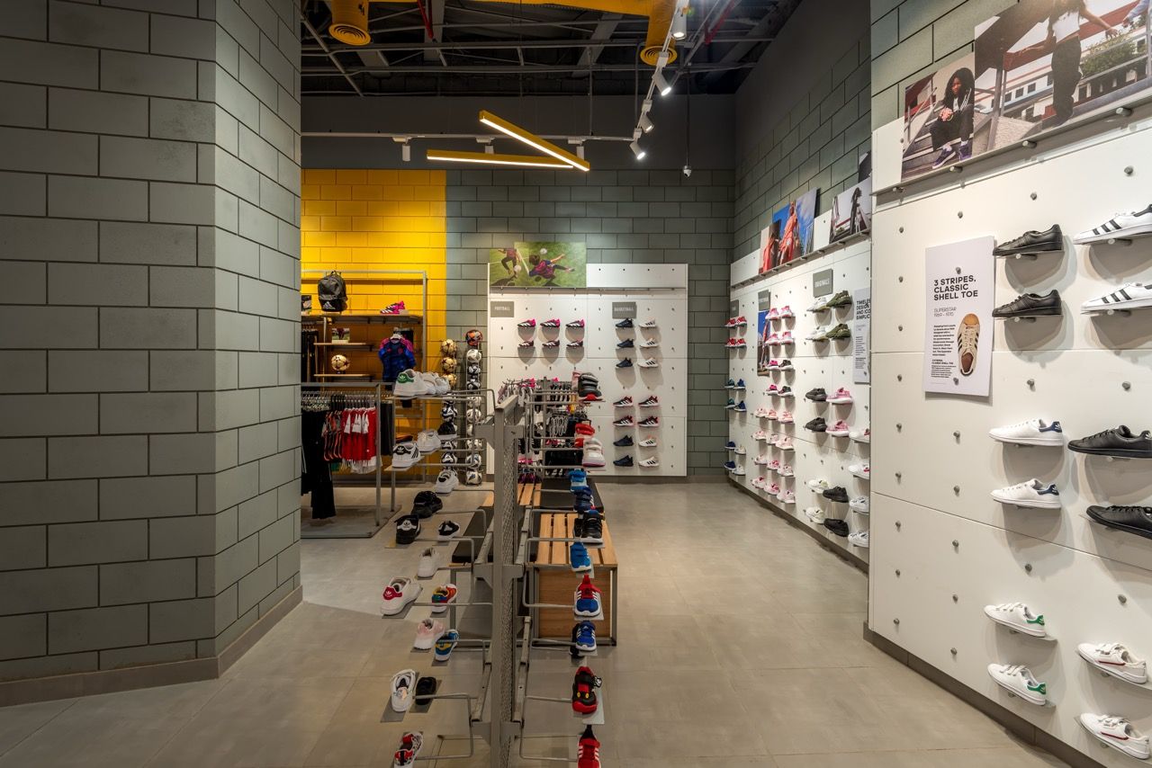 A wide-angle, exterior view of the **Lloyd's Building** in London, showcasing its distinctive inside-out architecture with exposed pipes, ducts, and service elements on the facade. The building stands tall against the skyline, reflecting the surrounding urban environment.