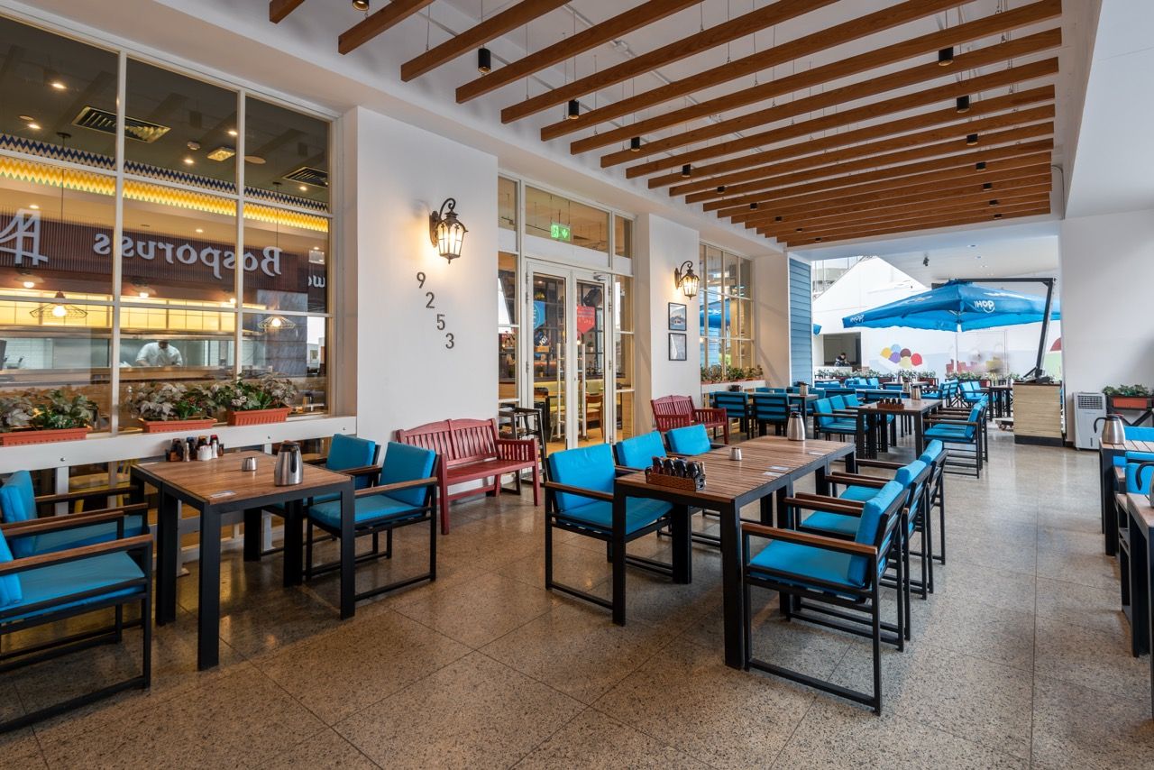 A wide-angle, exterior view of the **Lloyd's Building** in London, showcasing its distinctive inside-out architecture with exposed pipes, ducts, and service elements on the facade. The building stands tall against the skyline, reflecting the surrounding urban environment.