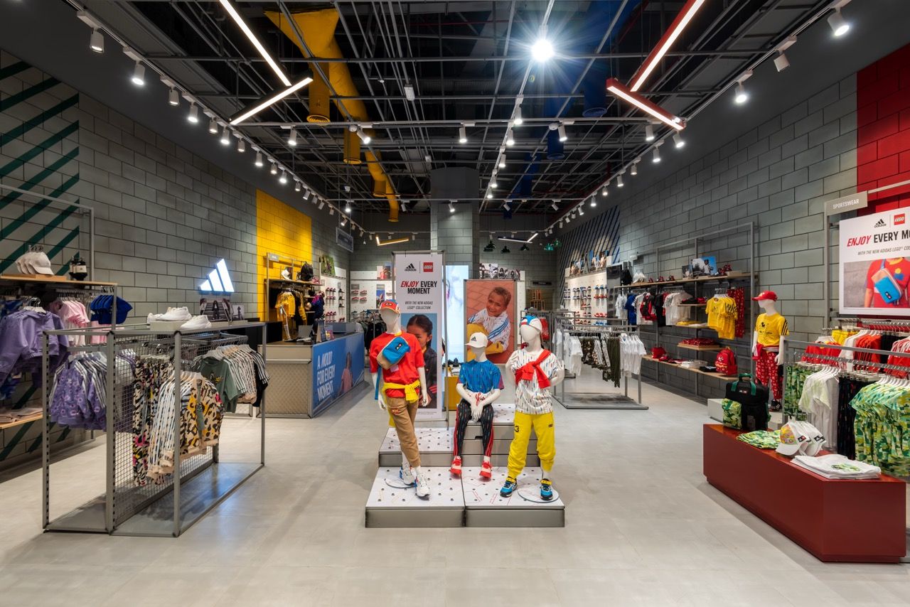 A wide-angle, exterior view of the **Lloyd's Building** in London, showcasing its distinctive inside-out architecture with exposed pipes, ducts, and service elements on the facade. The building stands tall against the skyline, reflecting the surrounding urban environment.