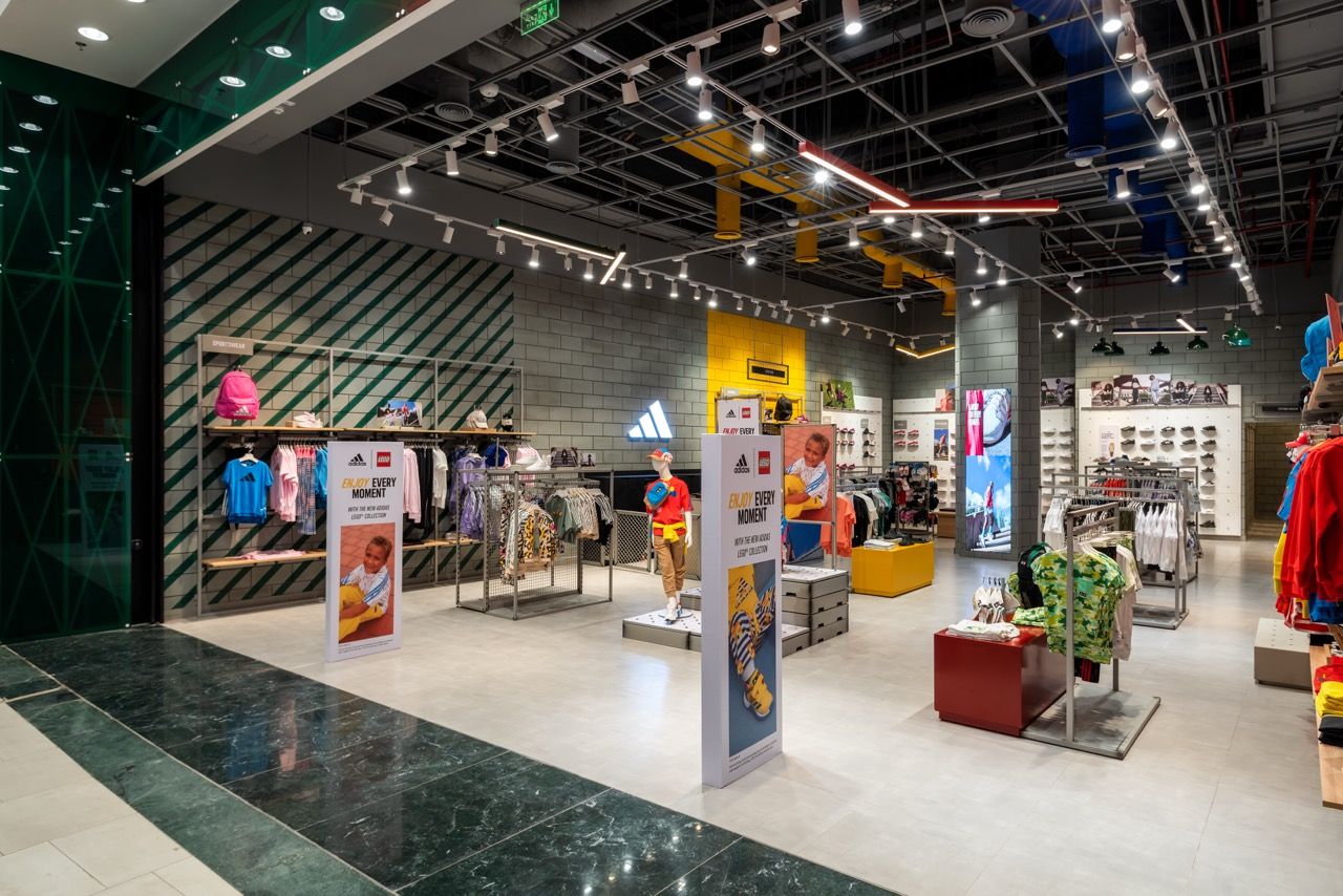 A wide-angle, exterior view of the **Lloyd's Building** in London, showcasing its distinctive inside-out architecture with exposed pipes, ducts, and service elements on the facade. The building stands tall against the skyline, reflecting the surrounding urban environment.