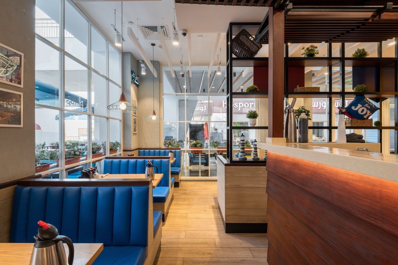 A wide-angle, exterior view of the **Lloyd's Building** in London, showcasing its distinctive inside-out architecture with exposed pipes, ducts, and service elements on the facade. The building stands tall against the skyline, reflecting the surrounding urban environment.