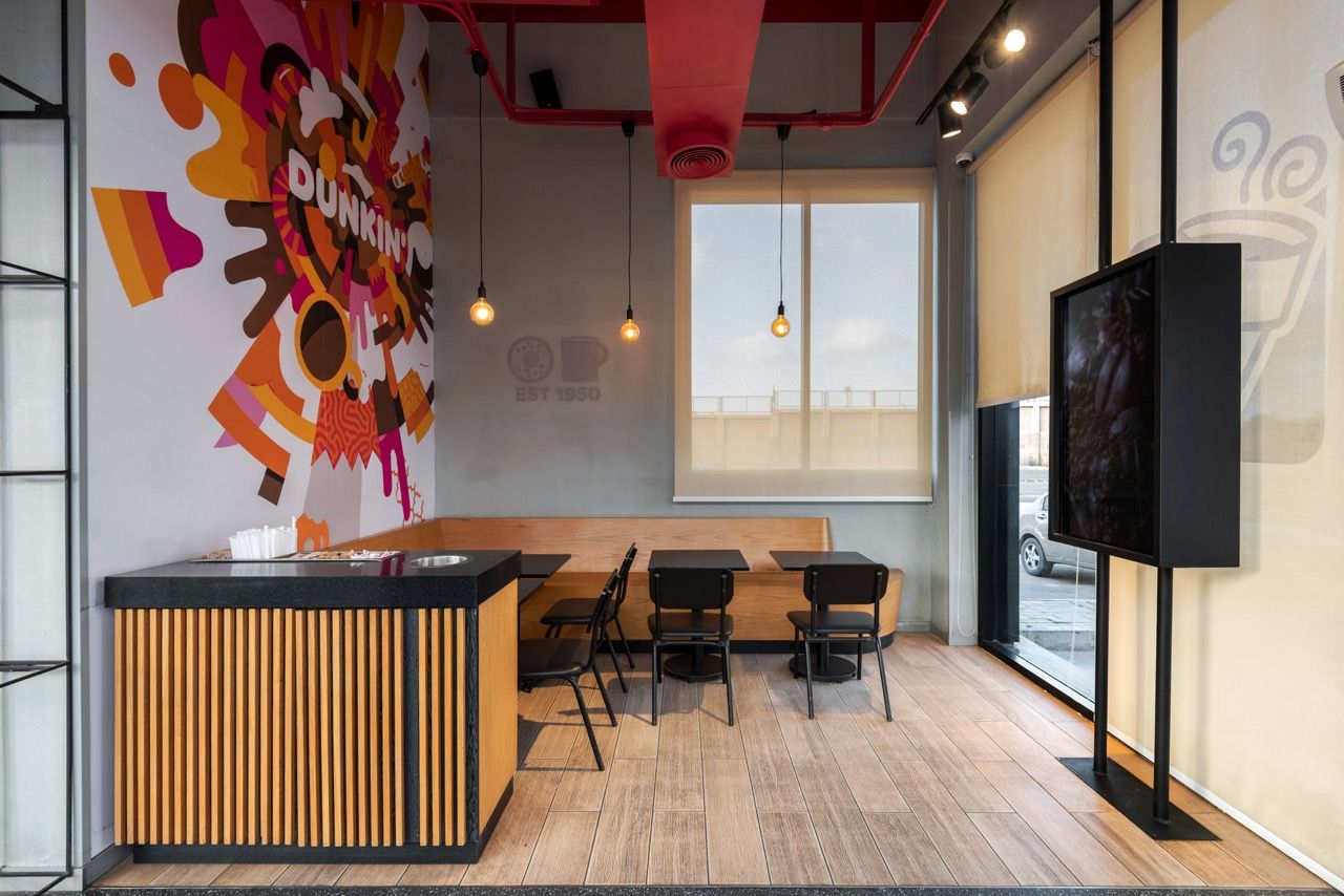 A wide-angle, exterior view of the **Lloyd's Building** in London, showcasing its distinctive inside-out architecture with exposed pipes, ducts, and service elements on the facade. The building stands tall against the skyline, reflecting the surrounding urban environment.