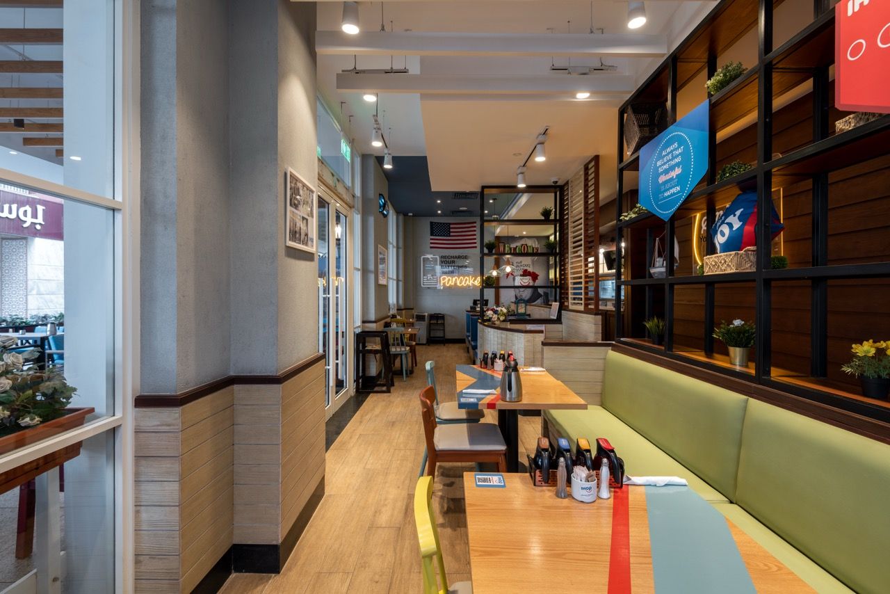 A wide-angle, exterior view of the **Lloyd's Building** in London, showcasing its distinctive inside-out architecture with exposed pipes, ducts, and service elements on the facade. The building stands tall against the skyline, reflecting the surrounding urban environment.