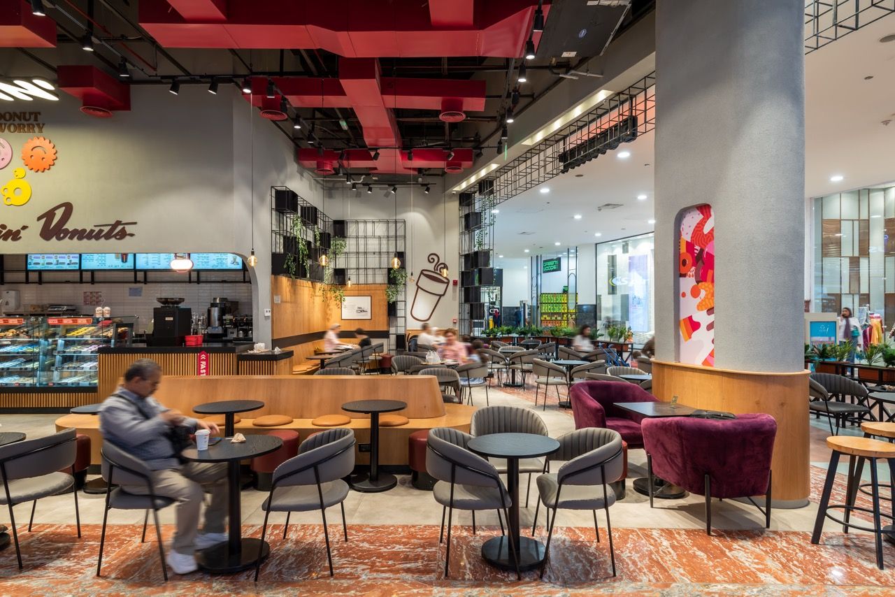 A wide-angle, exterior view of the **Lloyd's Building** in London, showcasing its distinctive inside-out architecture with exposed pipes, ducts, and service elements on the facade. The building stands tall against the skyline, reflecting the surrounding urban environment.