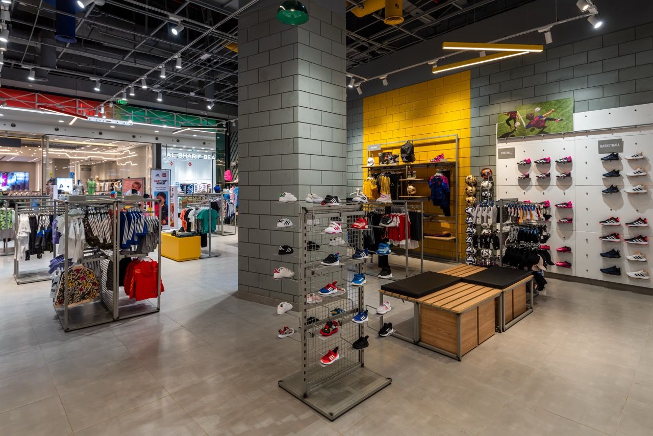 A wide-angle, exterior view of the **Lloyd's Building** in London, showcasing its distinctive inside-out architecture with exposed pipes, ducts, and service elements on the facade. The building stands tall against the skyline, reflecting the surrounding urban environment.