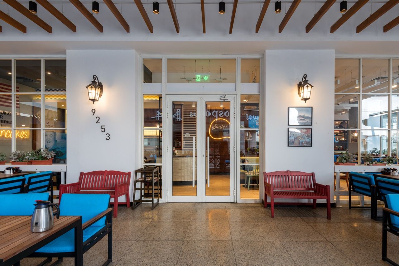 A wide-angle, exterior view of the **Lloyd's Building** in London, showcasing its distinctive inside-out architecture with exposed pipes, ducts, and service elements on the facade. The building stands tall against the skyline, reflecting the surrounding urban environment.