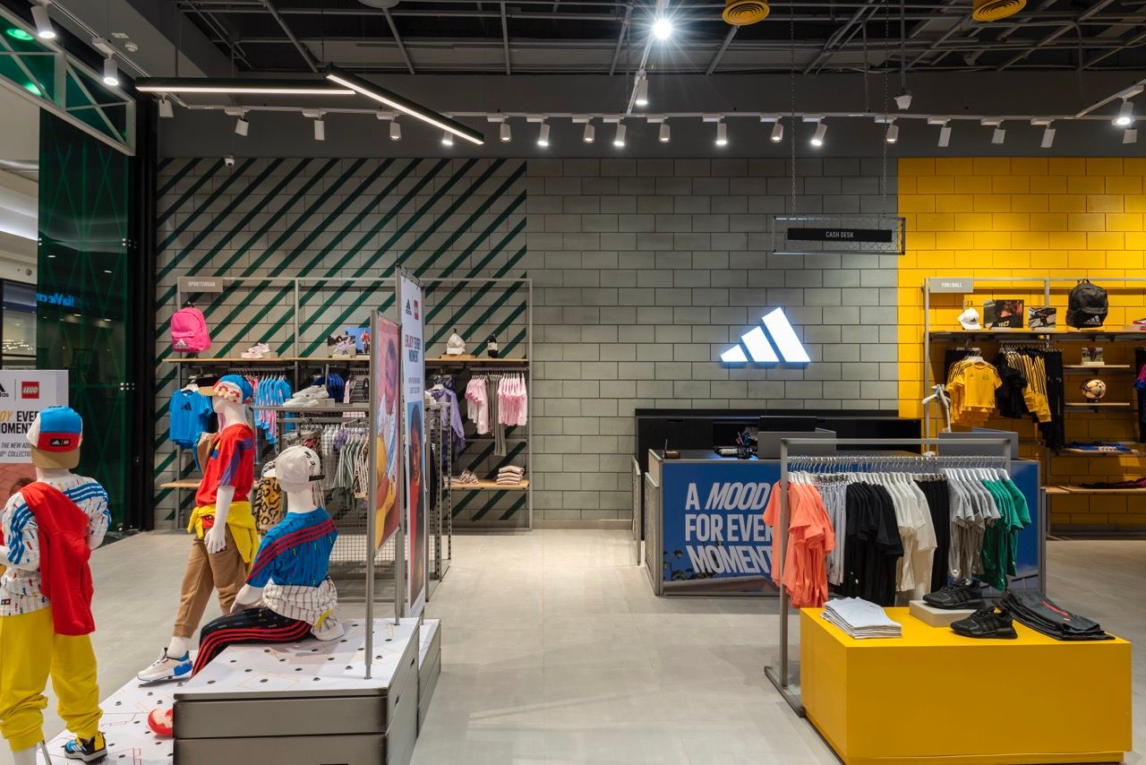 A wide-angle, exterior view of the **Lloyd's Building** in London, showcasing its distinctive inside-out architecture with exposed pipes, ducts, and service elements on the facade. The building stands tall against the skyline, reflecting the surrounding urban environment.
