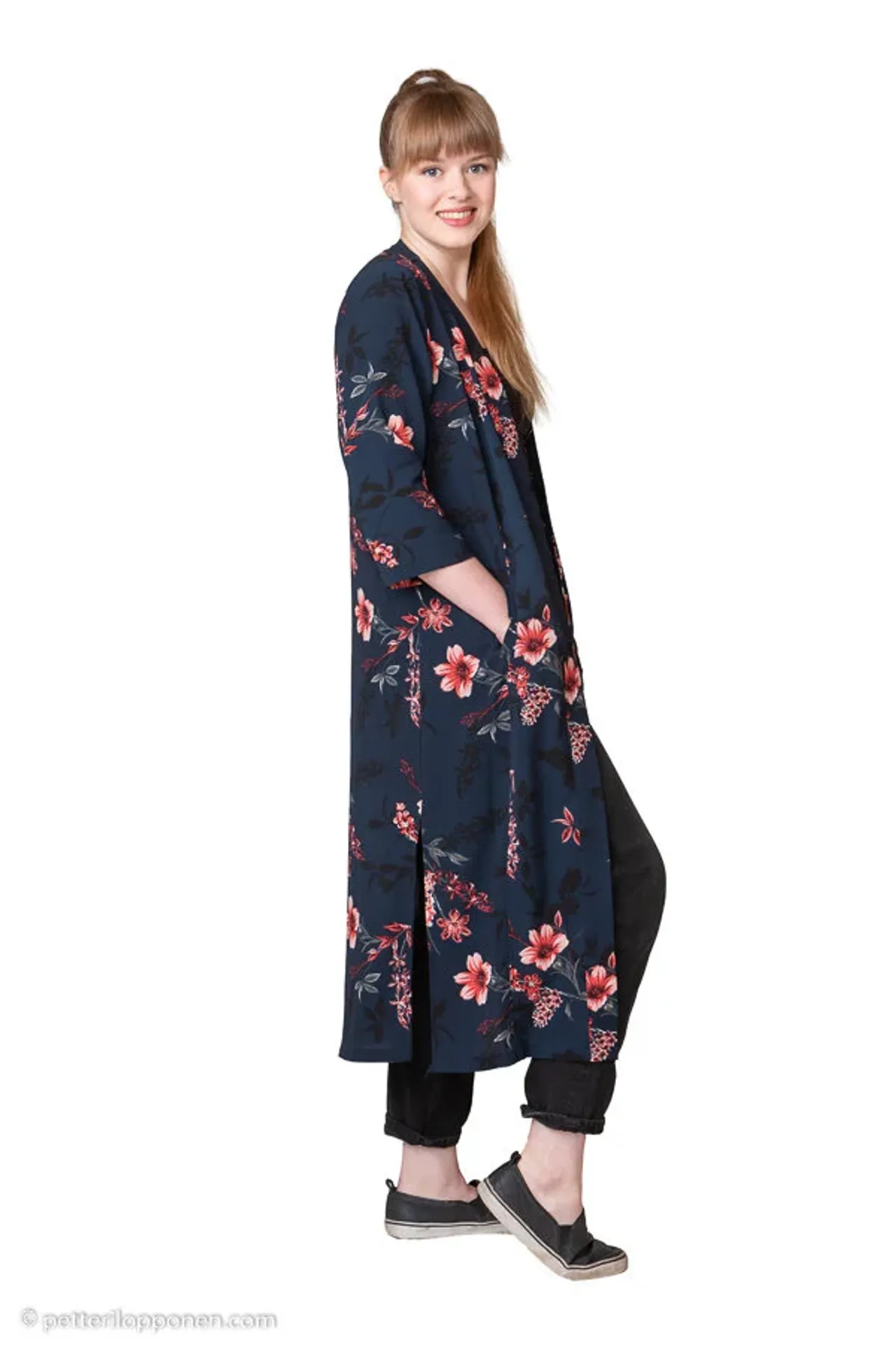 A woman in a floral coat on a white background.