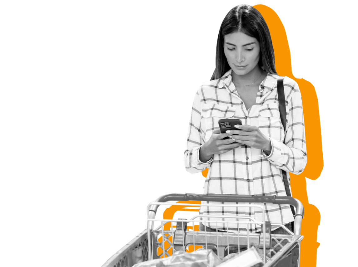 A woman looks at her SNAP account online on her phone against a yellow background.