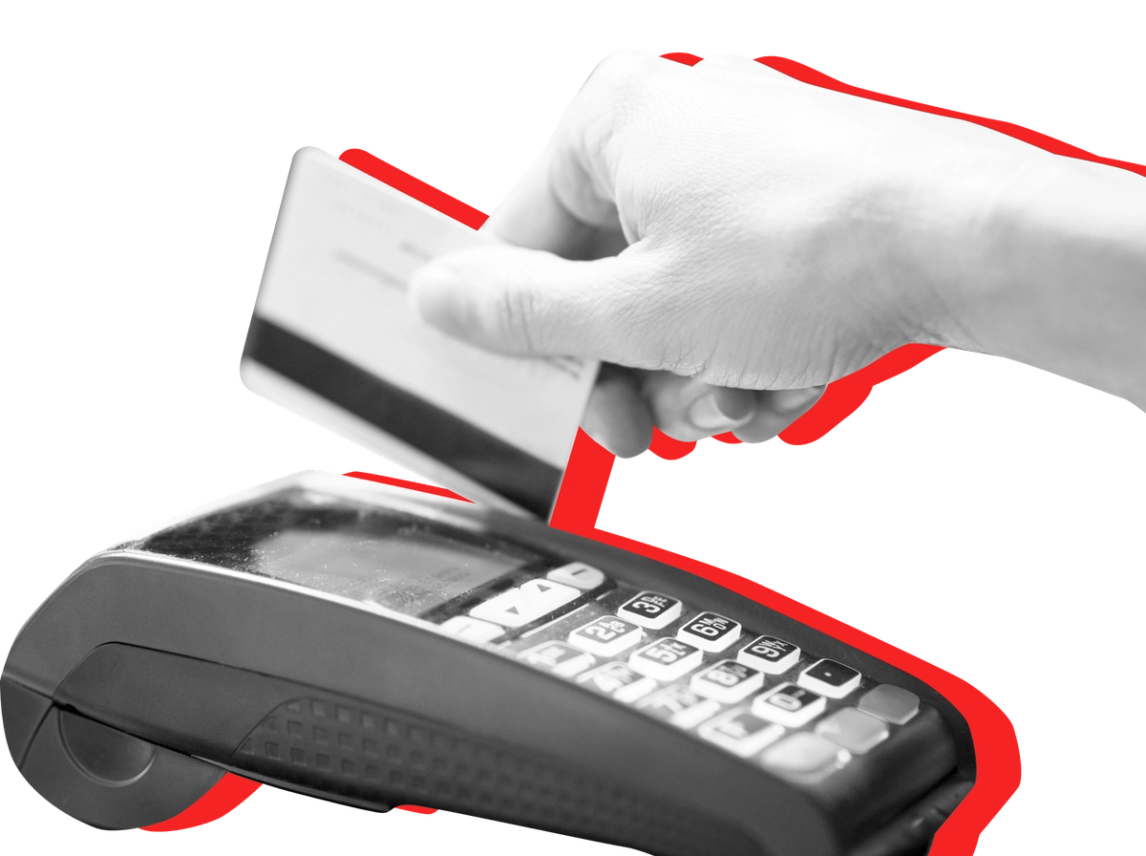 A hand slides a card through a card reader against a red background.
