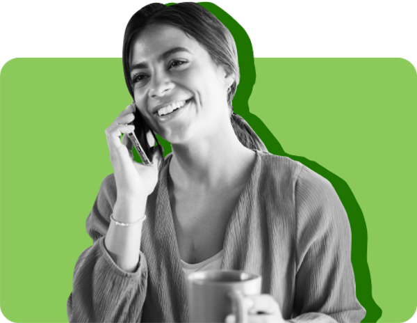 A woman smiles as she talks to her SNAP caseworker over the phone against a green background 