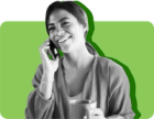 A woman smiles as she talks to her SNAP caseworker over the phone against a green background 