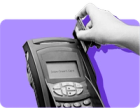A hand swipes an EBT card on a card reader against a purple background