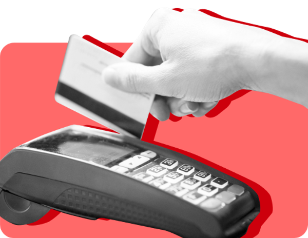A hand slides a card through a card reader against a red background..