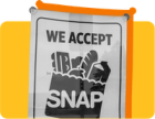 A sign that says "We accept SNAP" against a yellow background