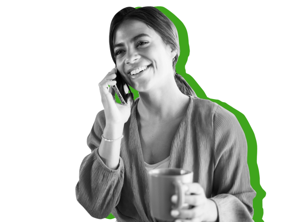 Woman on phone holding cup of coffee