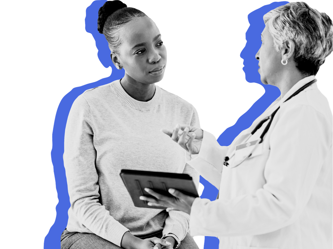 An emergency room doctor shows a patient on Medicaid some information on a tablet against a blue background.