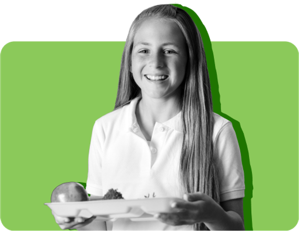 A student holds a tray of free lunch at a public school where universal free lunch is offered.