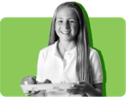 A student holds a tray of free lunch at a public school where universal free lunch is offered.