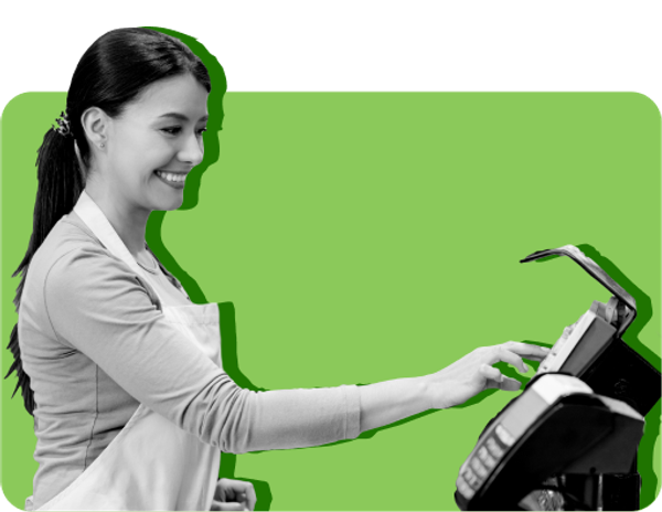 A woman rings up groceries against a green background.