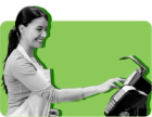 A woman rings up groceries at a checkout against a green background.