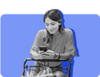 A woman looks at her phone at the grocery store