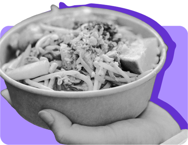 A hot taco bowl held against a purple background. Hot foods are not eligible for purchase with EBT.