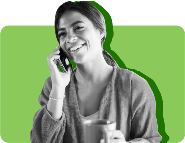 Woman on phone holding cup of coffee