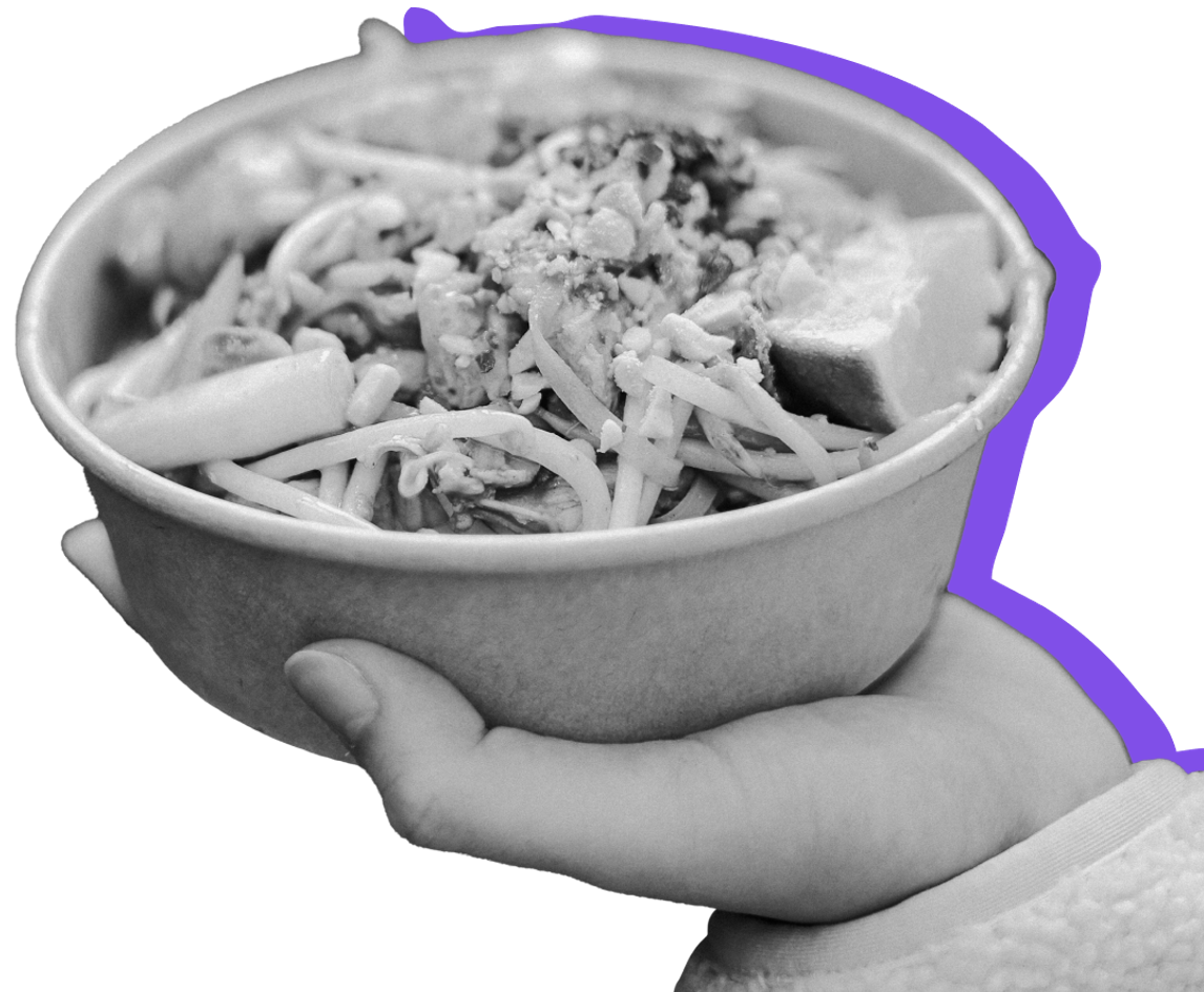 A hot taco bowl held against a purple background. Hot foods are not eligible for purchase with EBT.