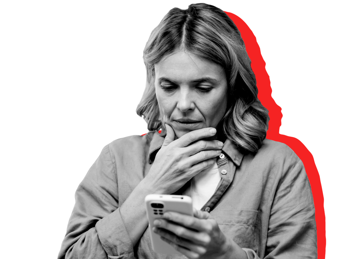A SNAP recipient looks at her SNAP denial notice on her phone against a red background