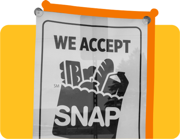 A sign that reads "We accept SNAP" against a yellow background