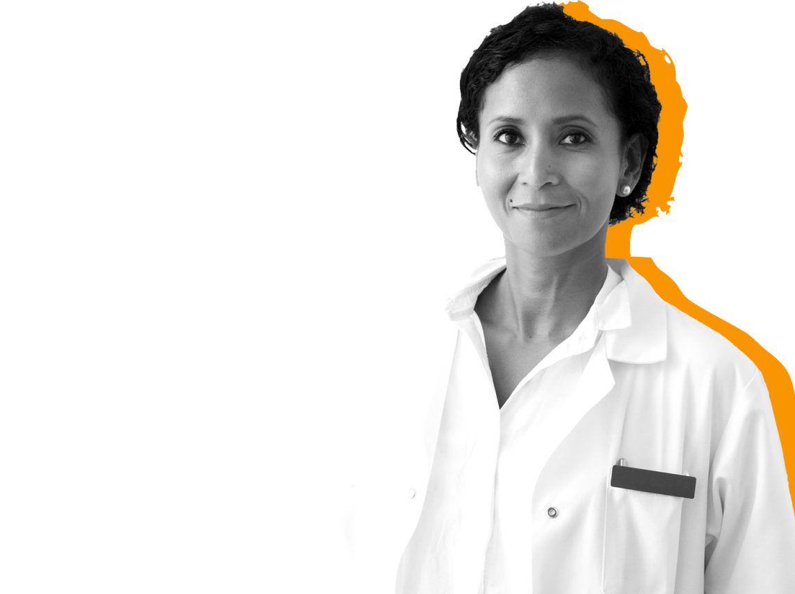 A eye doctor who takes Medicaid wears a white coat and stands against a yellow background