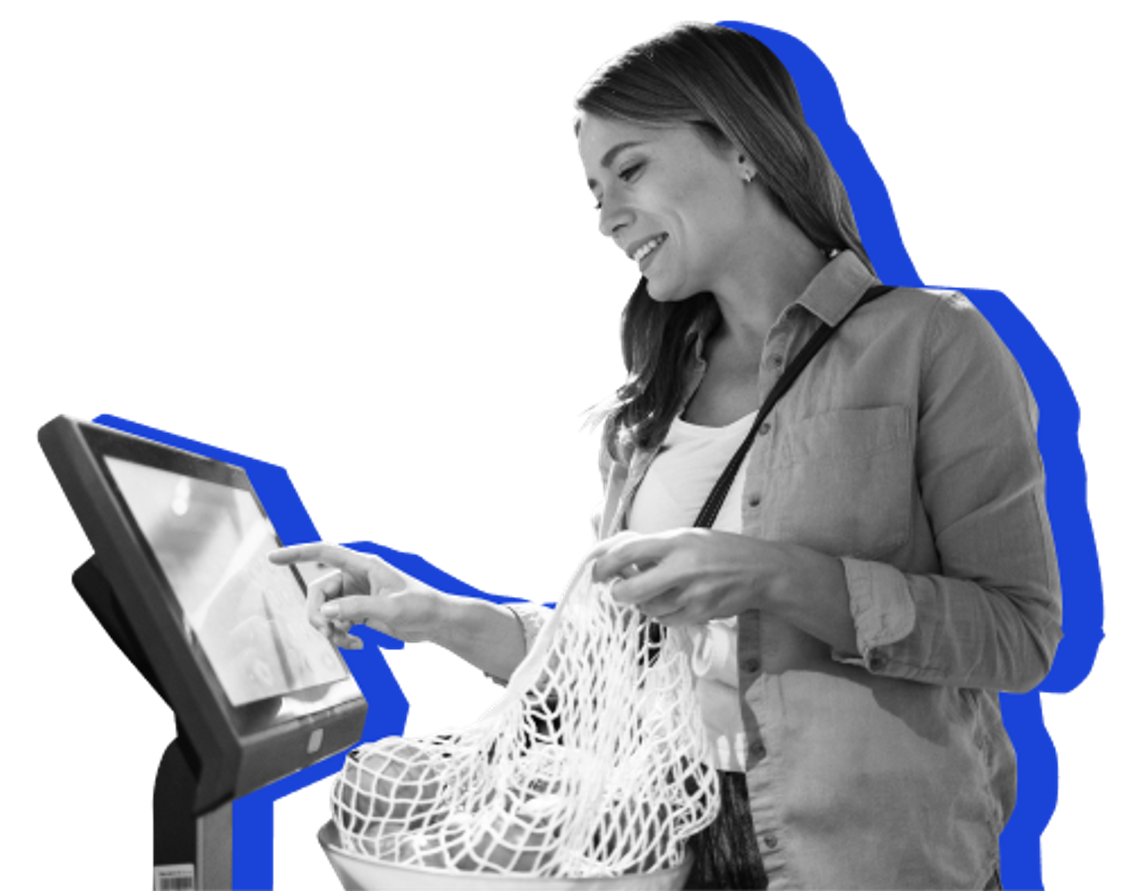 A woman pays for her groceries using a self-checkout machine. 