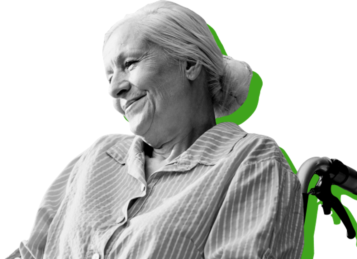 smiling woman with white hair sitting in wheelchair