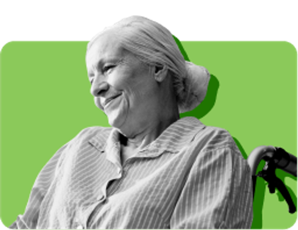 smiling woman with white hair sitting in wheelchair