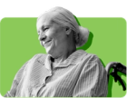 smiling woman with white hair sitting in wheelchair