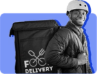 A delivery guy with an insulated bag and a bike helmet on stands in front of a blue background