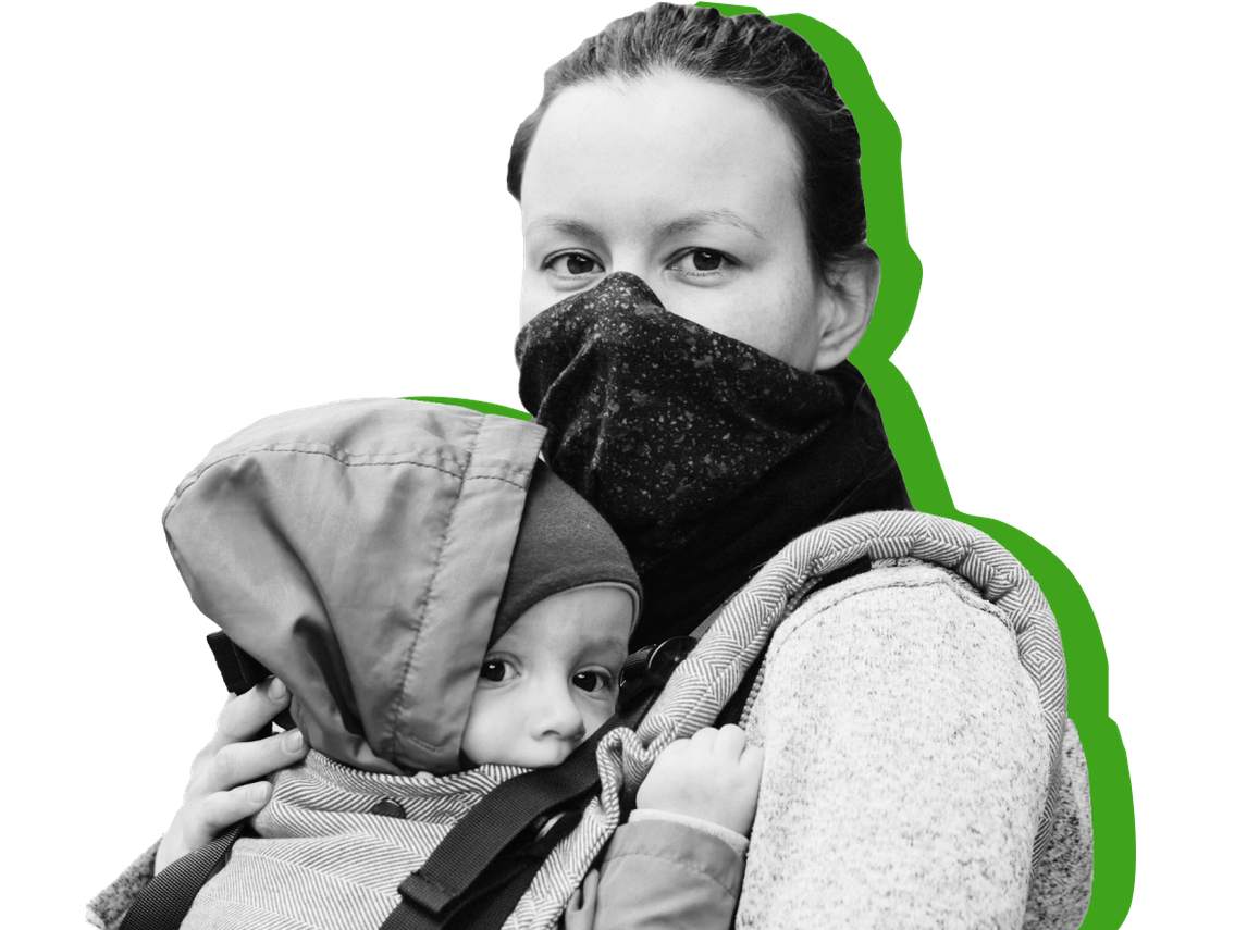 Woman in a mask holding her child.