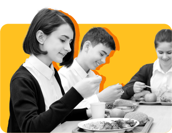 Students sit together eating lunch against a yellow backdrop