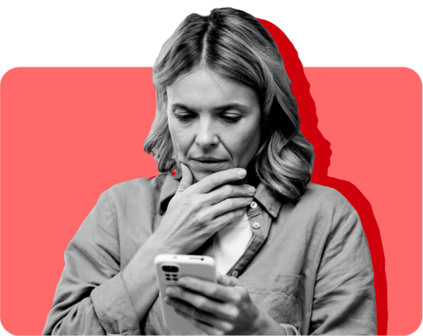 A SNAP recipient looks at her SNAP denial notice on her phone against a red background