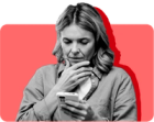 A SNAP recipient looks at her SNAP denial notice on her phone against a red background