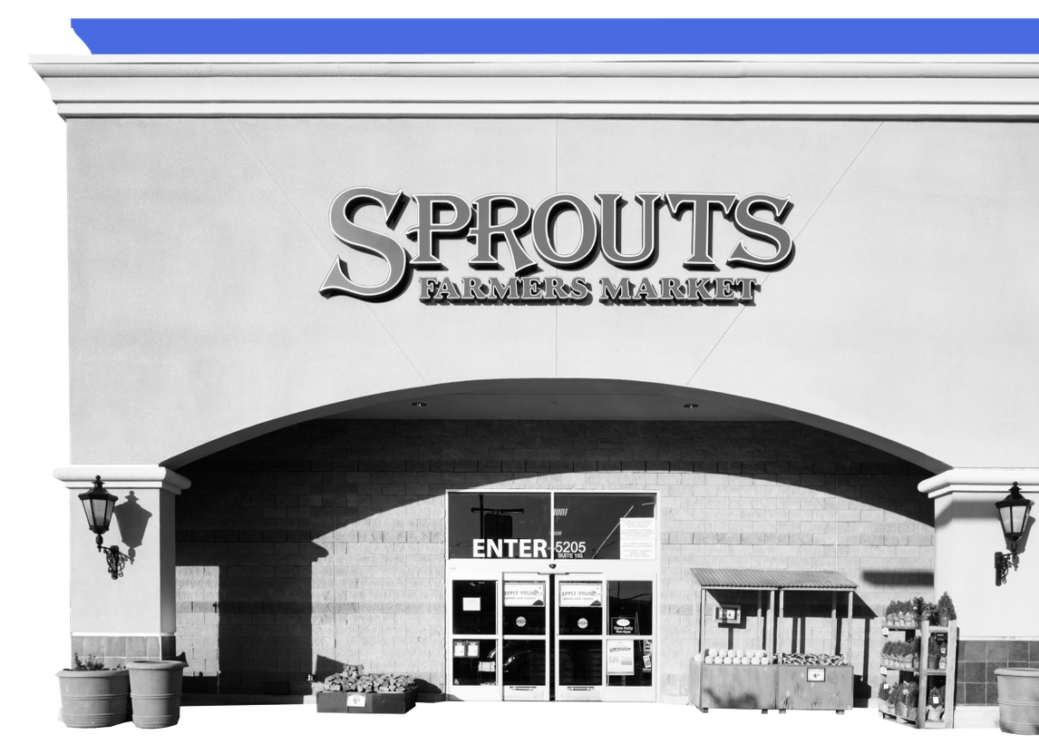 An image showing the exterior entrance of a Sprouts store against a blue background