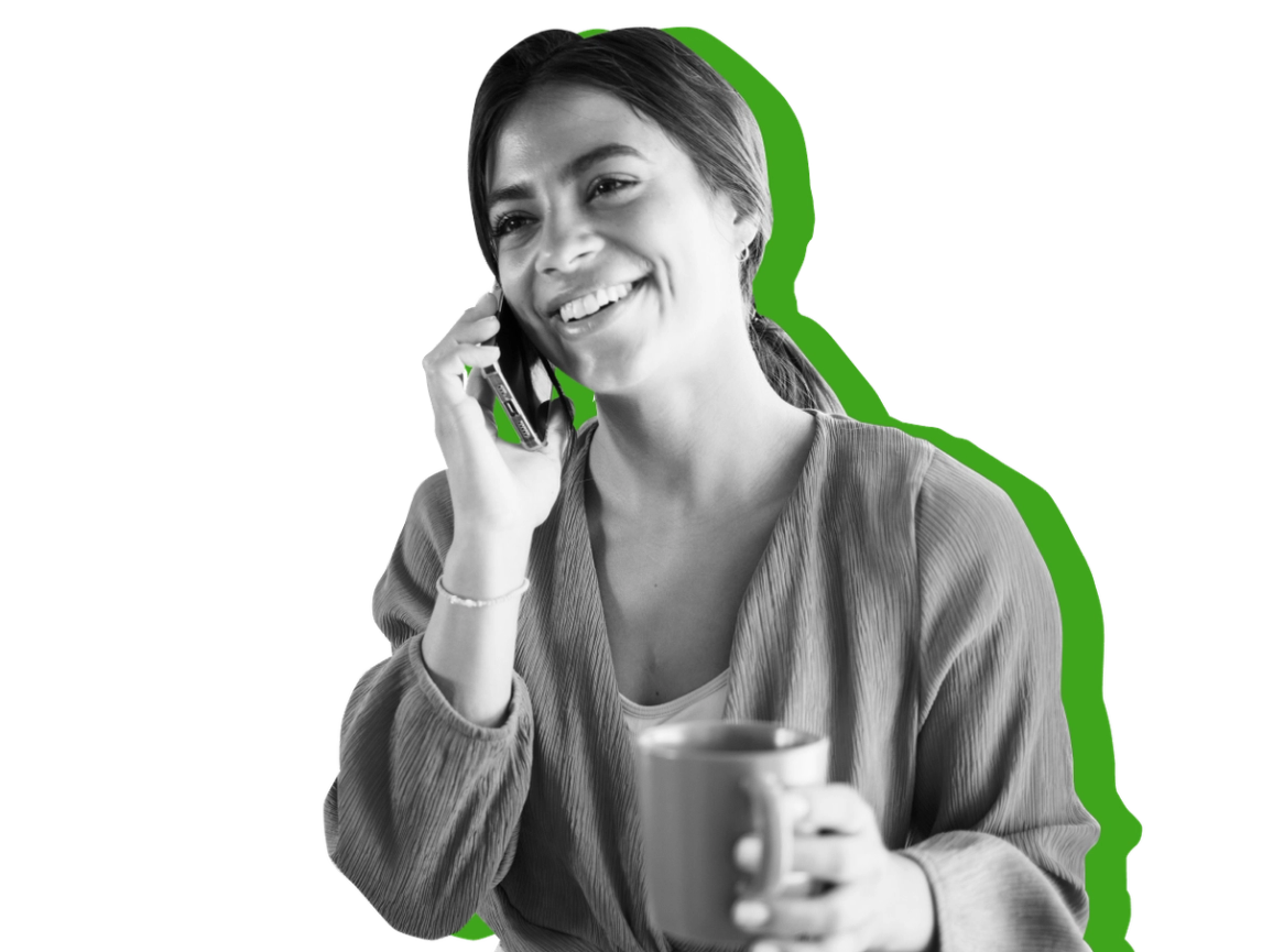 A woman smiles as she talks to her SNAP caseworker over the phone against a green background