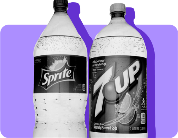 A bottle of Sprite and a bottle of 7 Up stand next to each other. 