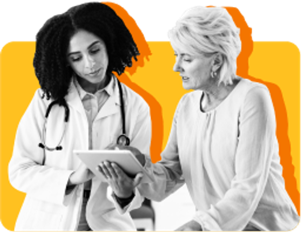 Black female doctor wearing a stethoscope, looking at tablet with white female patient